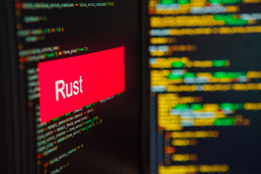 Programming,Language,,Rust,Inscription,On,The,Background,Of,Computer,Code.